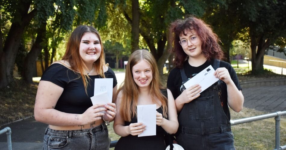 Happy students holding results