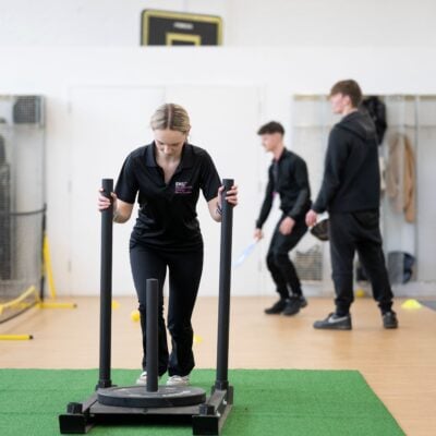 Student pushing weights