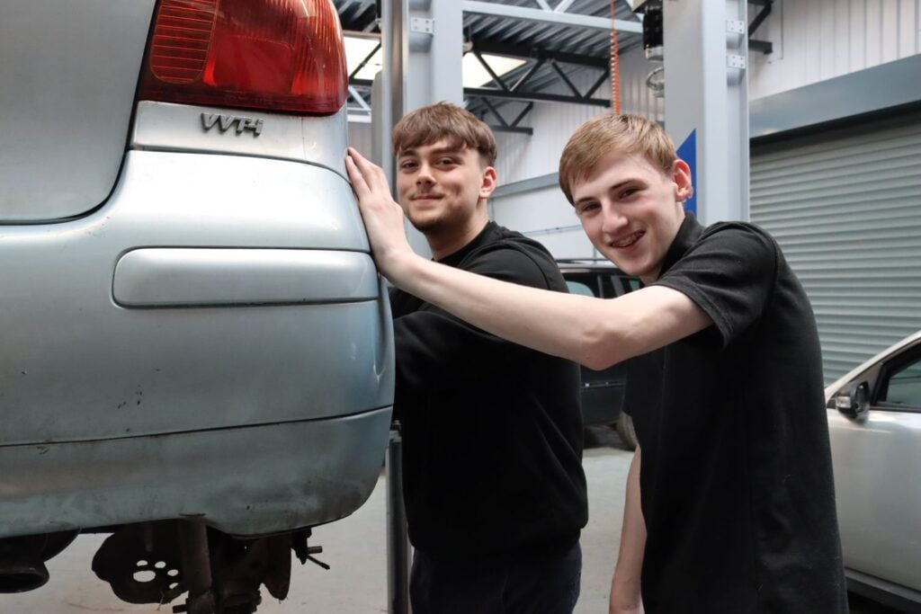Two students in automotive workshop