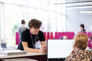 Student chatting to a receptionist