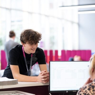 Student chatting to a receptionist