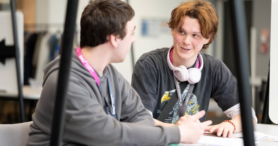 Students sat at a desk chatting