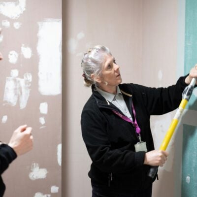 Painting and Decorating lecturer demonstrates to student