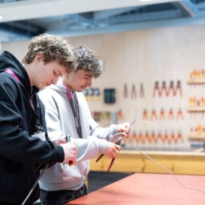 two electrical installation students in a workshop