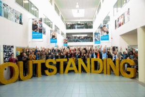 Outstanding letters with students stood behind cheering.