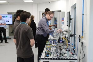 Engineering students working on an electrical board