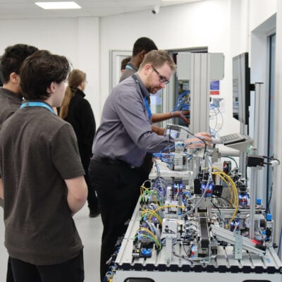 Engineering students working on an electrical board