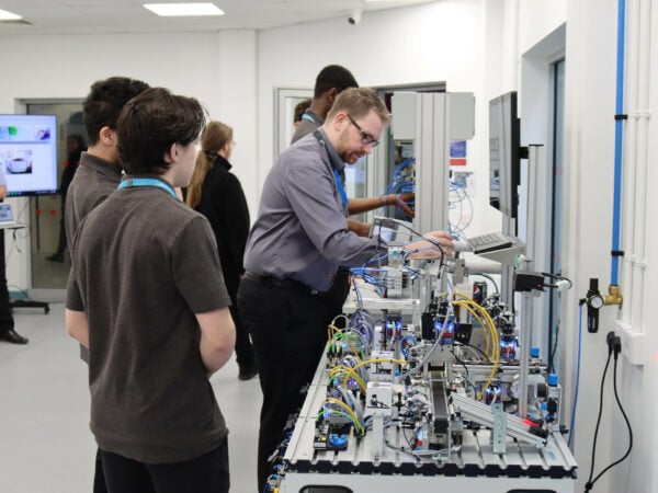 Engineering students working on an electrical board