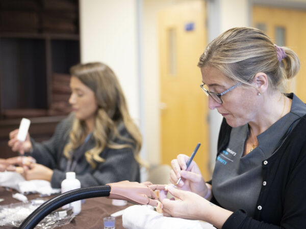 A beauty student practicing nails