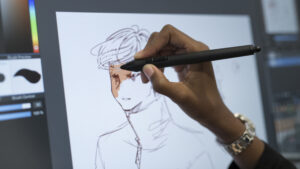 student working on an artpiece on the tablet