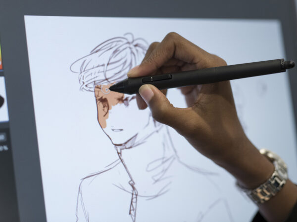 student working on an artpiece on the tablet