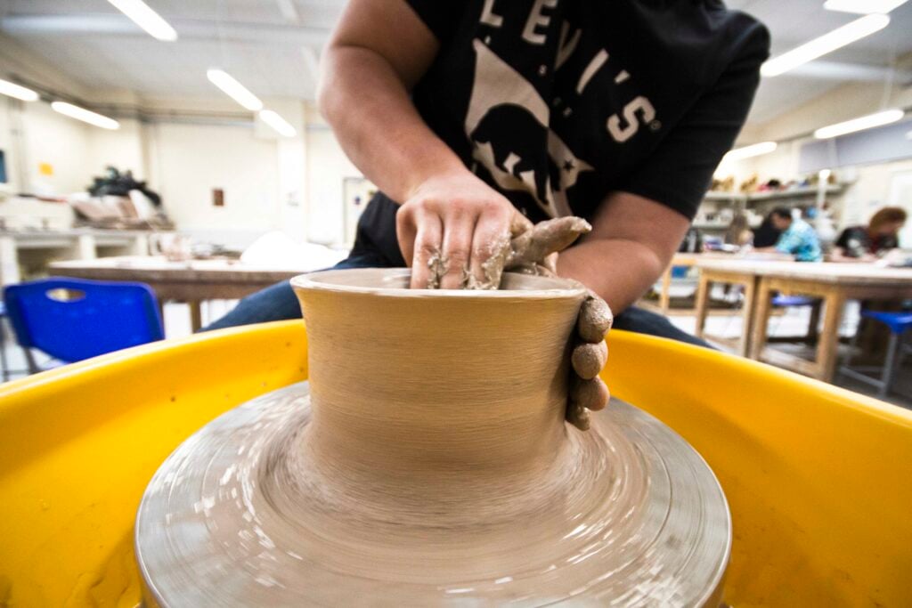 Sculpting student working on a piece