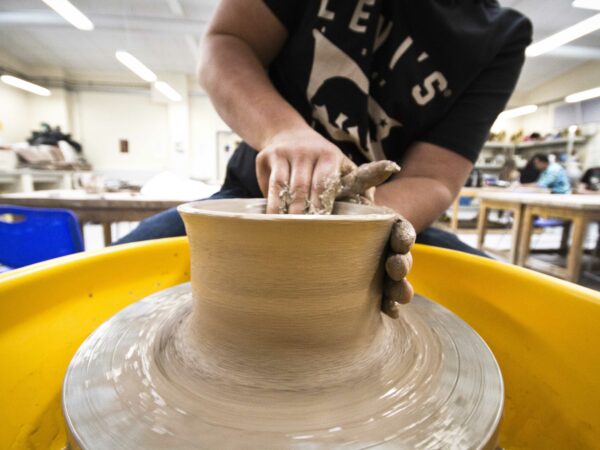 Sculpting student working on a piece