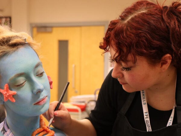 Beauty student working on a clients makeup