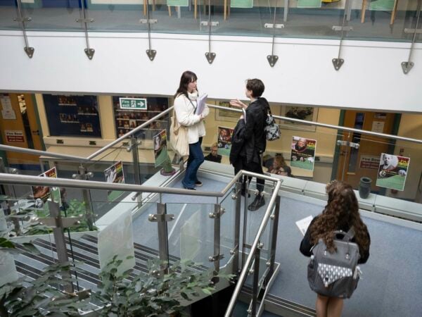 Students standing on the stairs talking