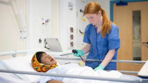 Student working in health simulation suite