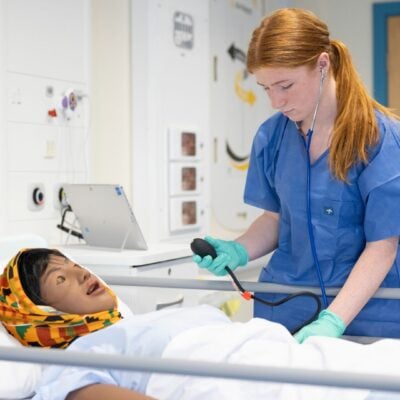 Student working in health simulation suite