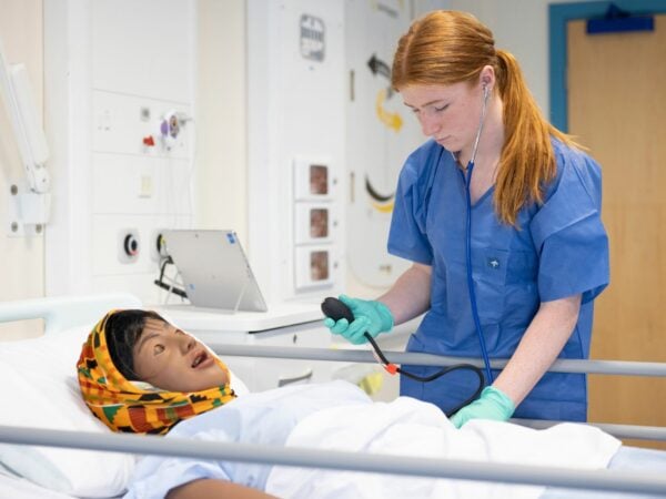 Student working in health simulation suite