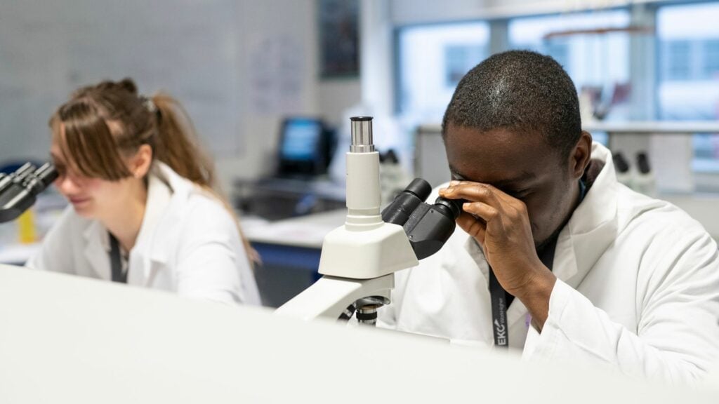 Science students using microscopes