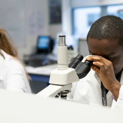 Science students using microscopes