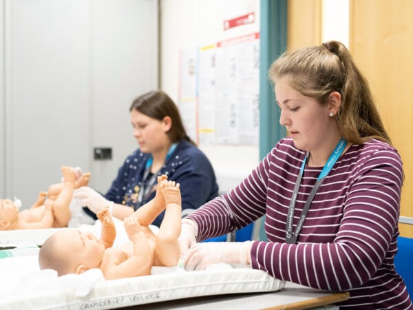 Early Years students practising changing a baby