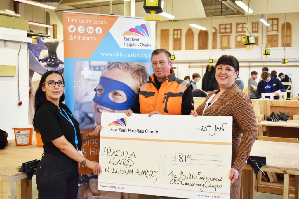 Industry Liaison Officer Chloe and Lecturer Darron give giant cheque to Dee Muligan from the NHS.