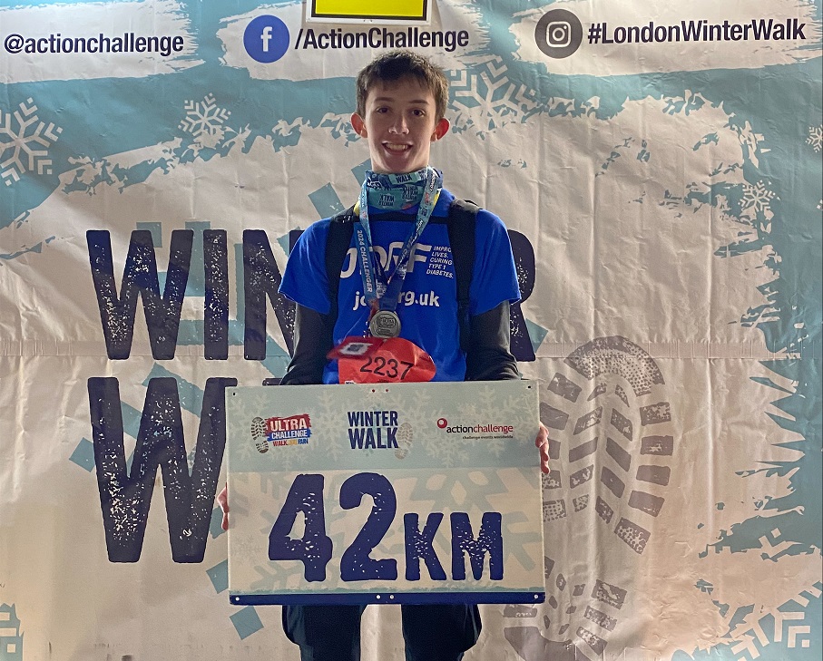 Scott Jacobs holding up completion sign after his London Winter Walk