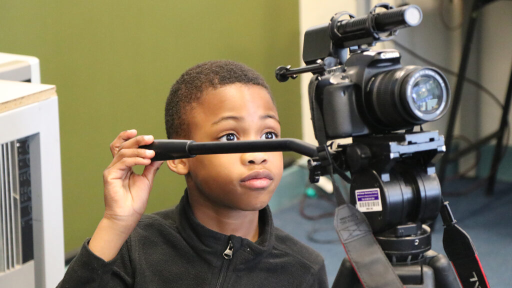 BRIT Kids student using a camera