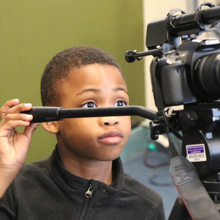 BRIT Kids student using a camera