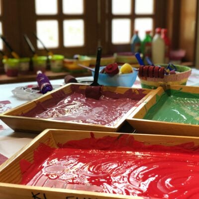 Paint and brushes in a nursery setting