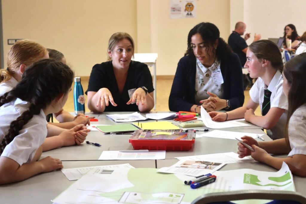students and mentors discuss engineering bridge project