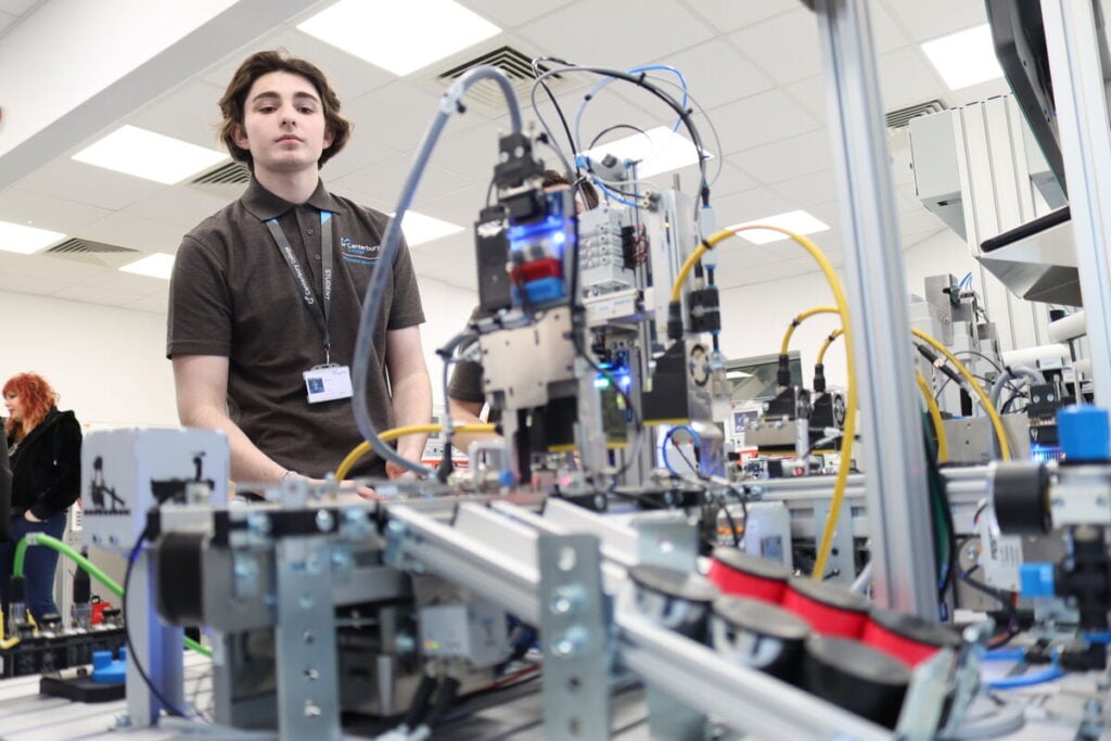 Student looking at a robot