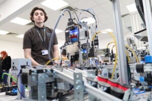 Student looking at a robot