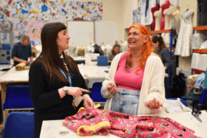 two adult learners in a sewing for beginners lesson
