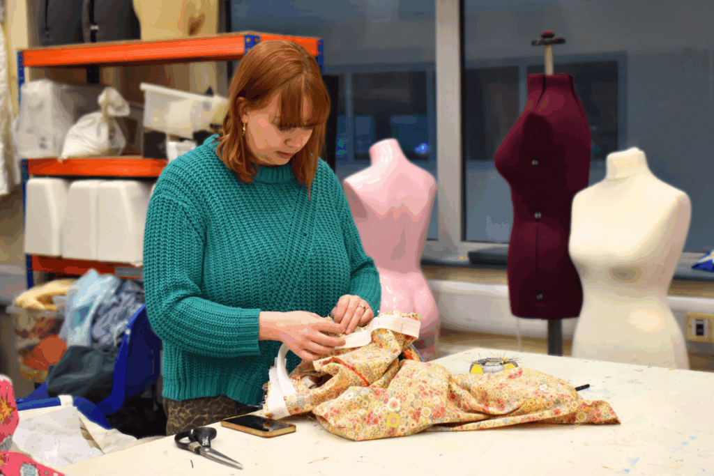 adult learner sewing in a sewing for beginners course