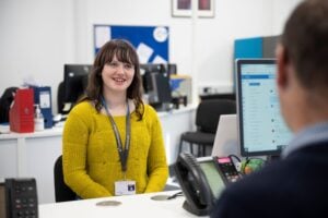 student speaks to college staff