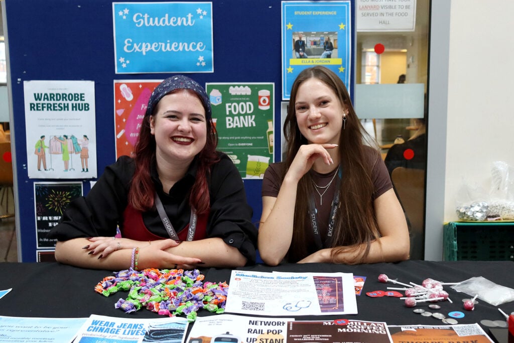 two students at a booth at the freshers fair