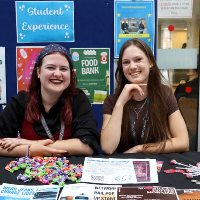 two students at a booth at the freshers fair