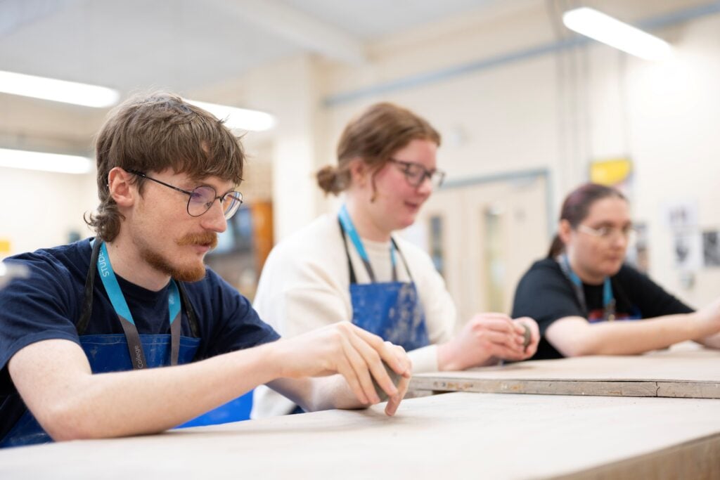 art and design students moulding clay ceramics