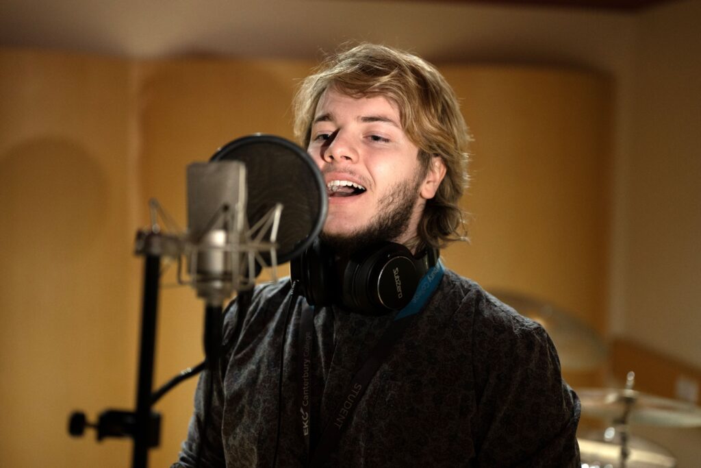 Student singing into a microphone