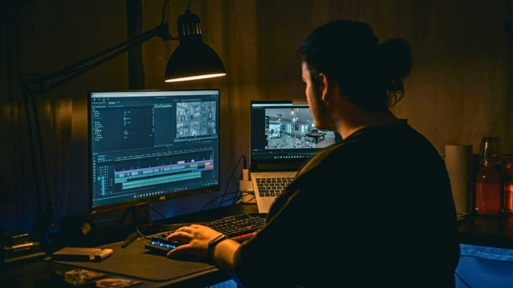 A man using video editing software on a computer