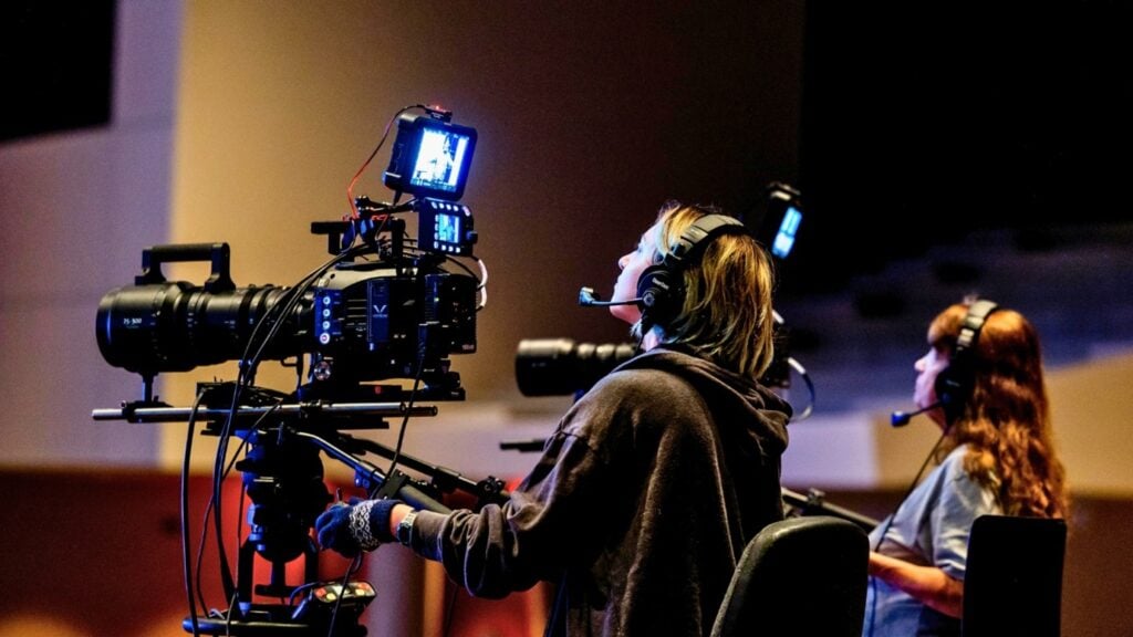 A person operating a video camera