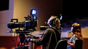 A person operating a video camera