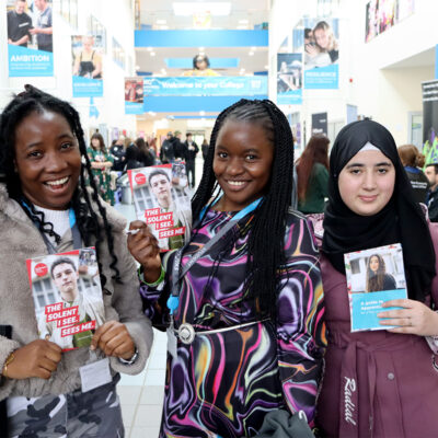 Three students smiling a camera