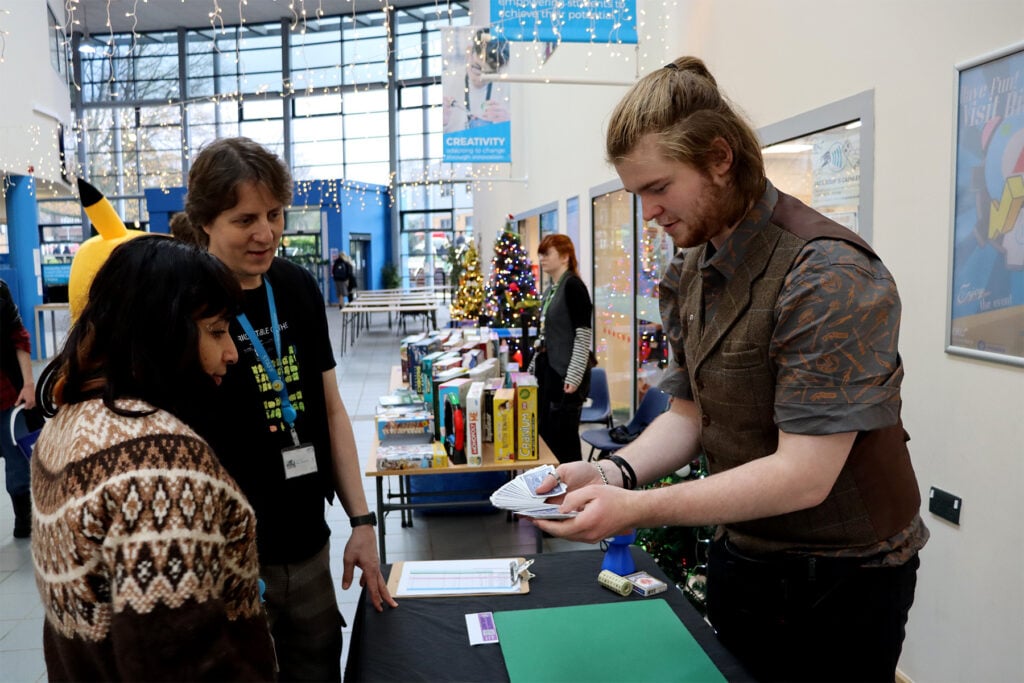 a student performs a magic trick at bitcrush event