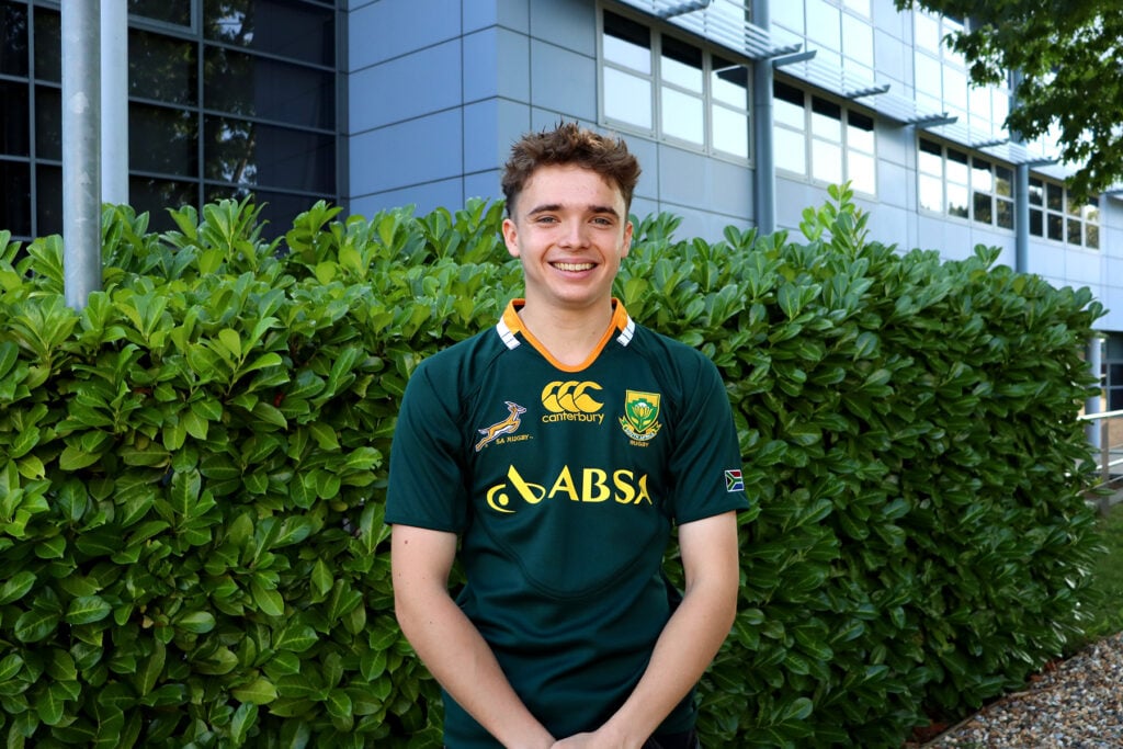 Young man standing outside smiling