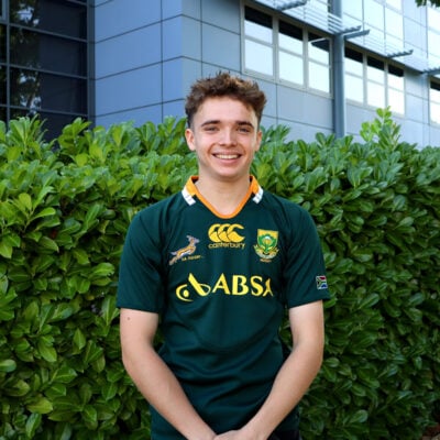 Young man standing outside smiling