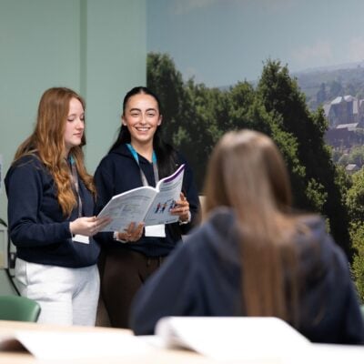 Students presenting in a boardroom