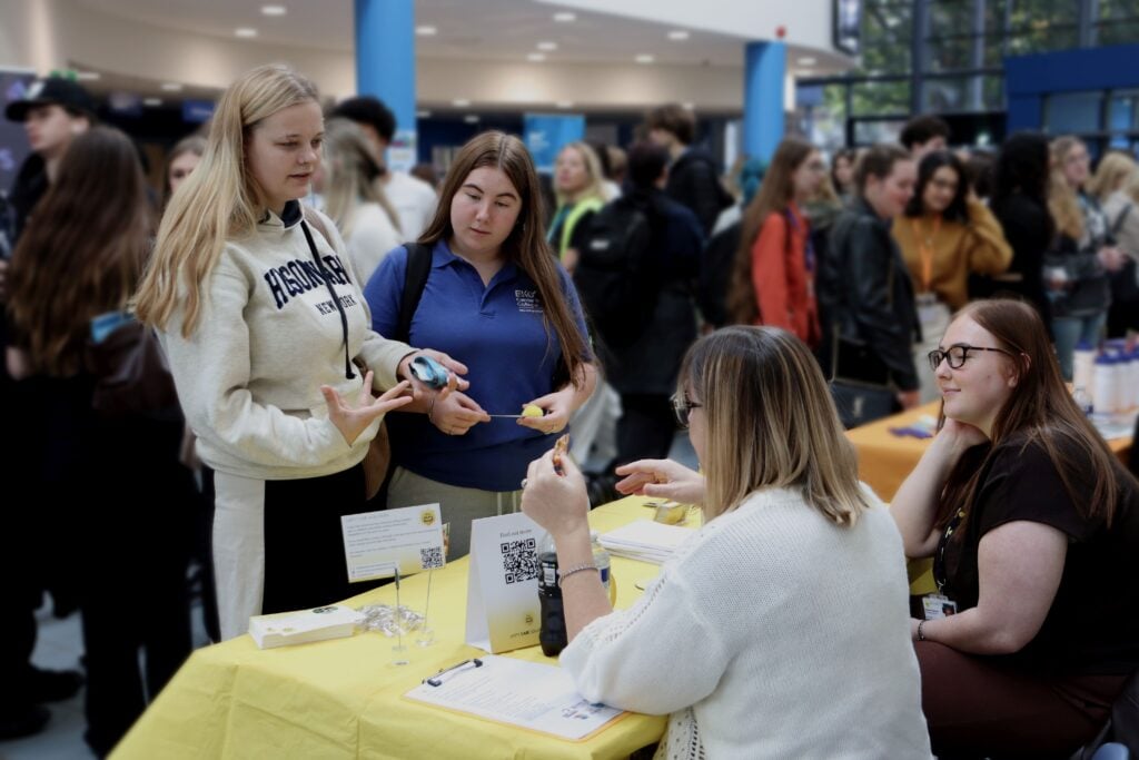 Students talking to exhibitor during careers fair