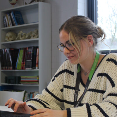 Access to HE student working with her laptop